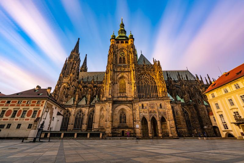 Sun-kissed Gothic cathedral against a tranquil plaza.